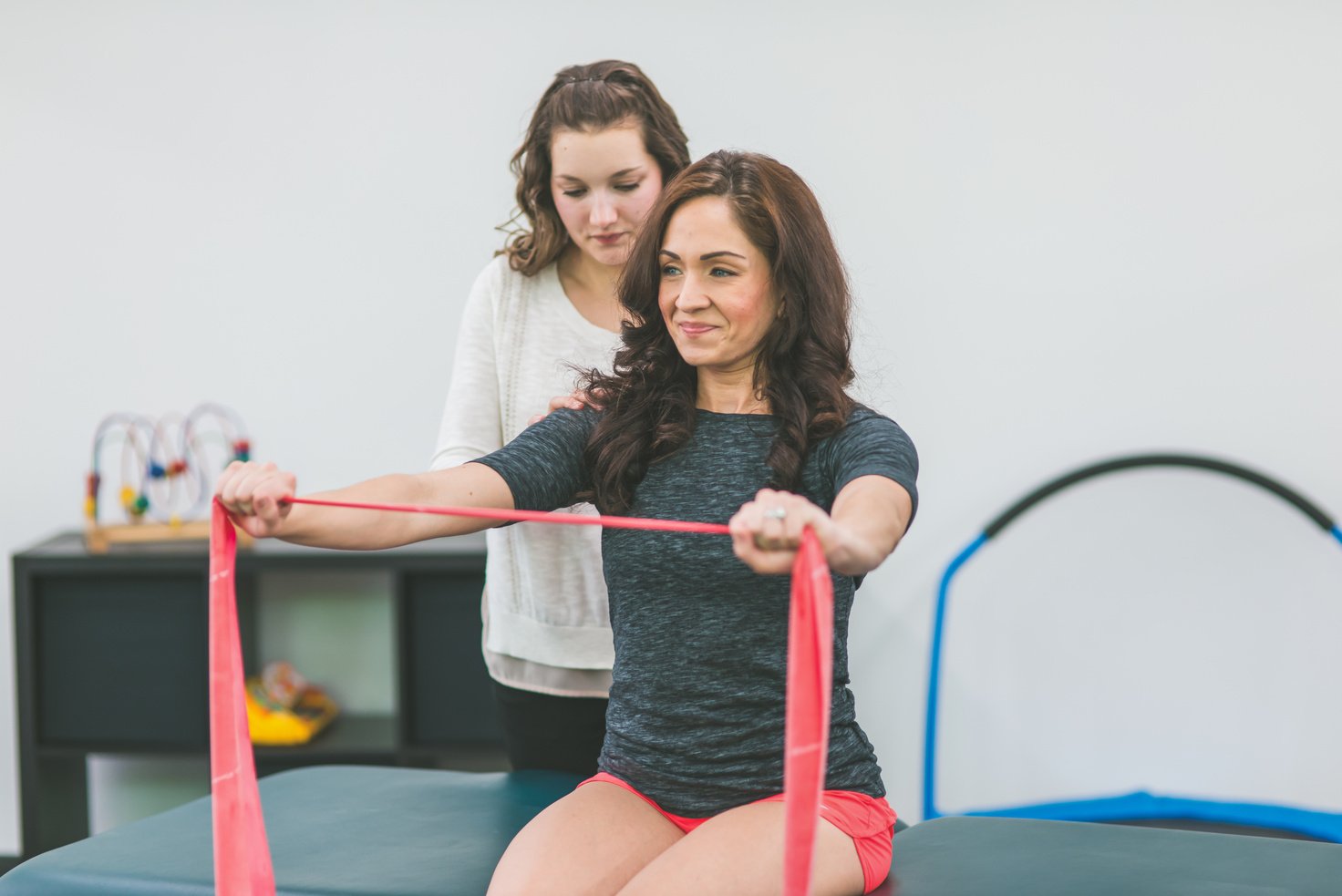 Adult female doing strength rehab in a physical therapy