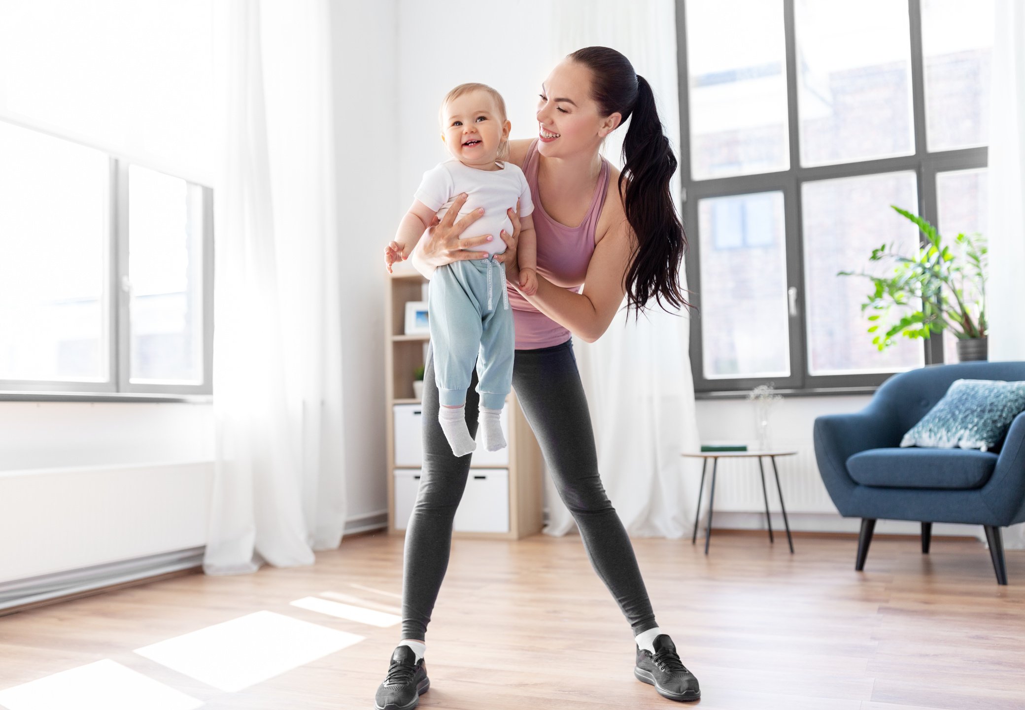 Happy Mother with Little Baby Exercising at Home